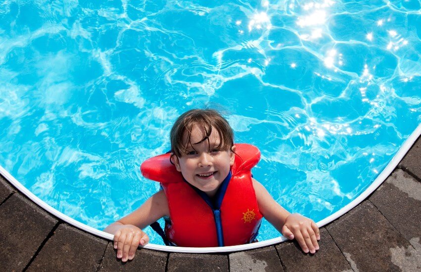 Child wearing lifejacket in pool