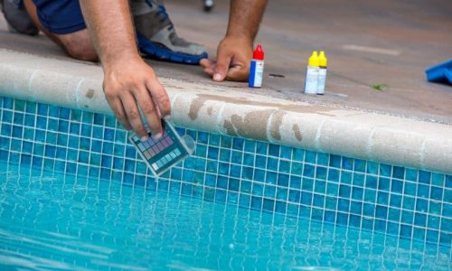 Technician testing pool water chemicals